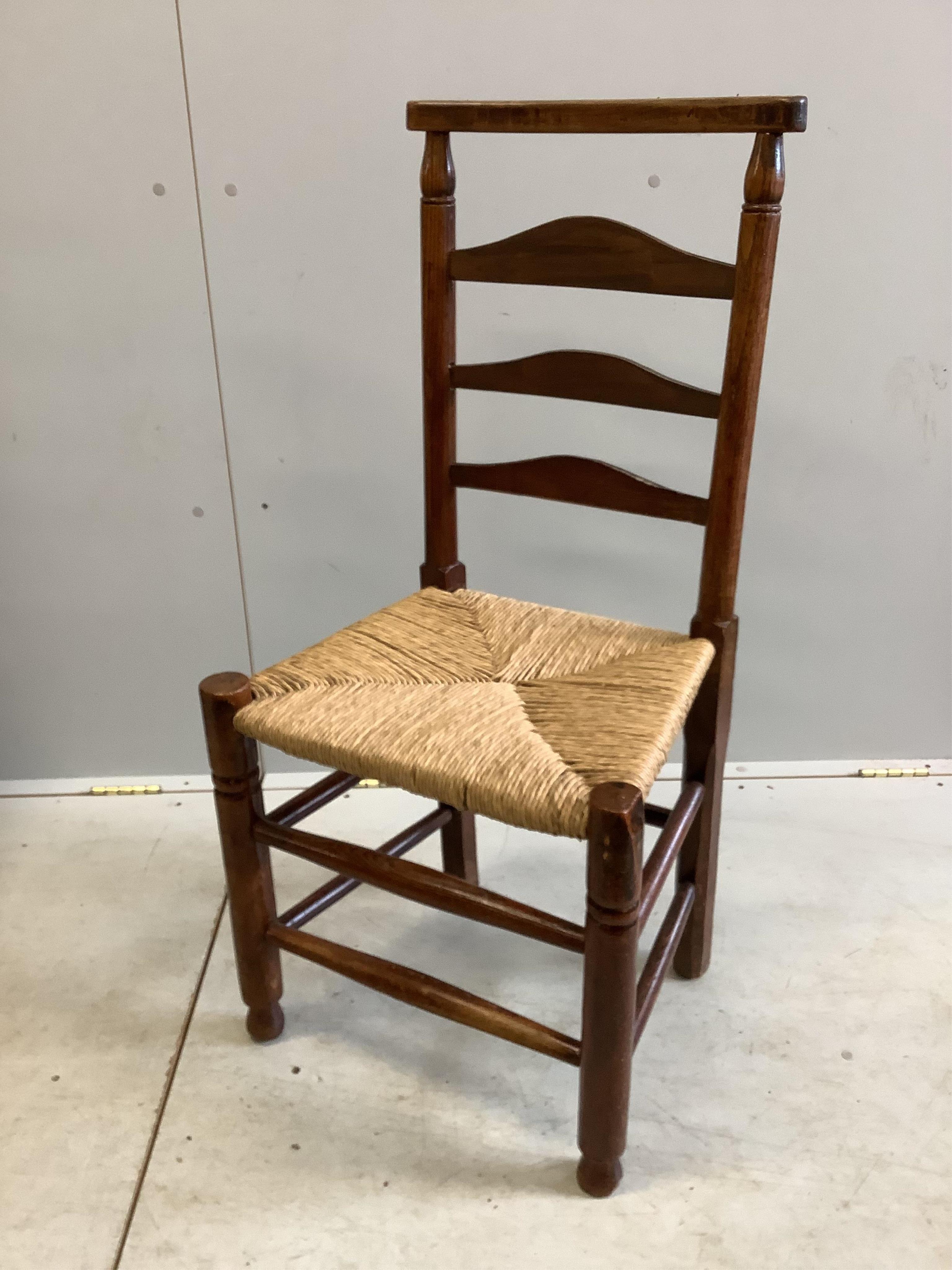 A set of four 19th century ash ladderback rush seat dining chairs. Condition - fair